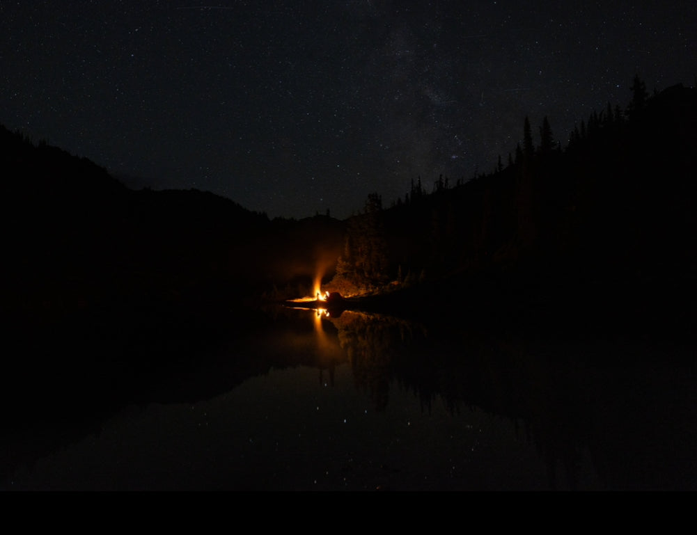 Pictured is a roaring campfire in a dark, starry, forested setting, announcing The Bight: Spooky Stories on 10/29 at 6:30 PM.