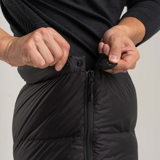 Studio detail view of the top side snap of the Helios Down pants