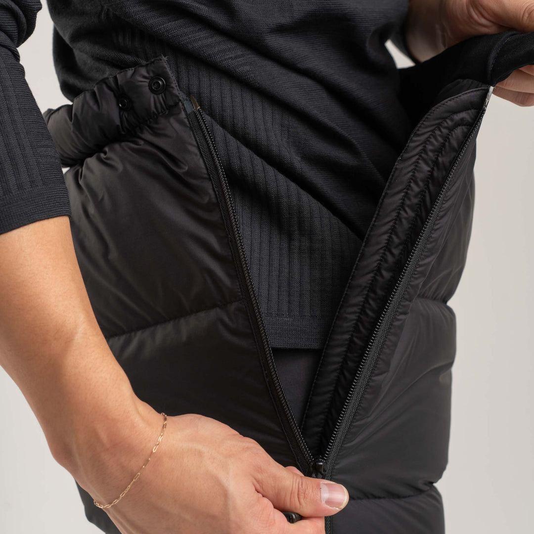 Studio detail view of the top side snap and side zipper of the Helios Down pants
