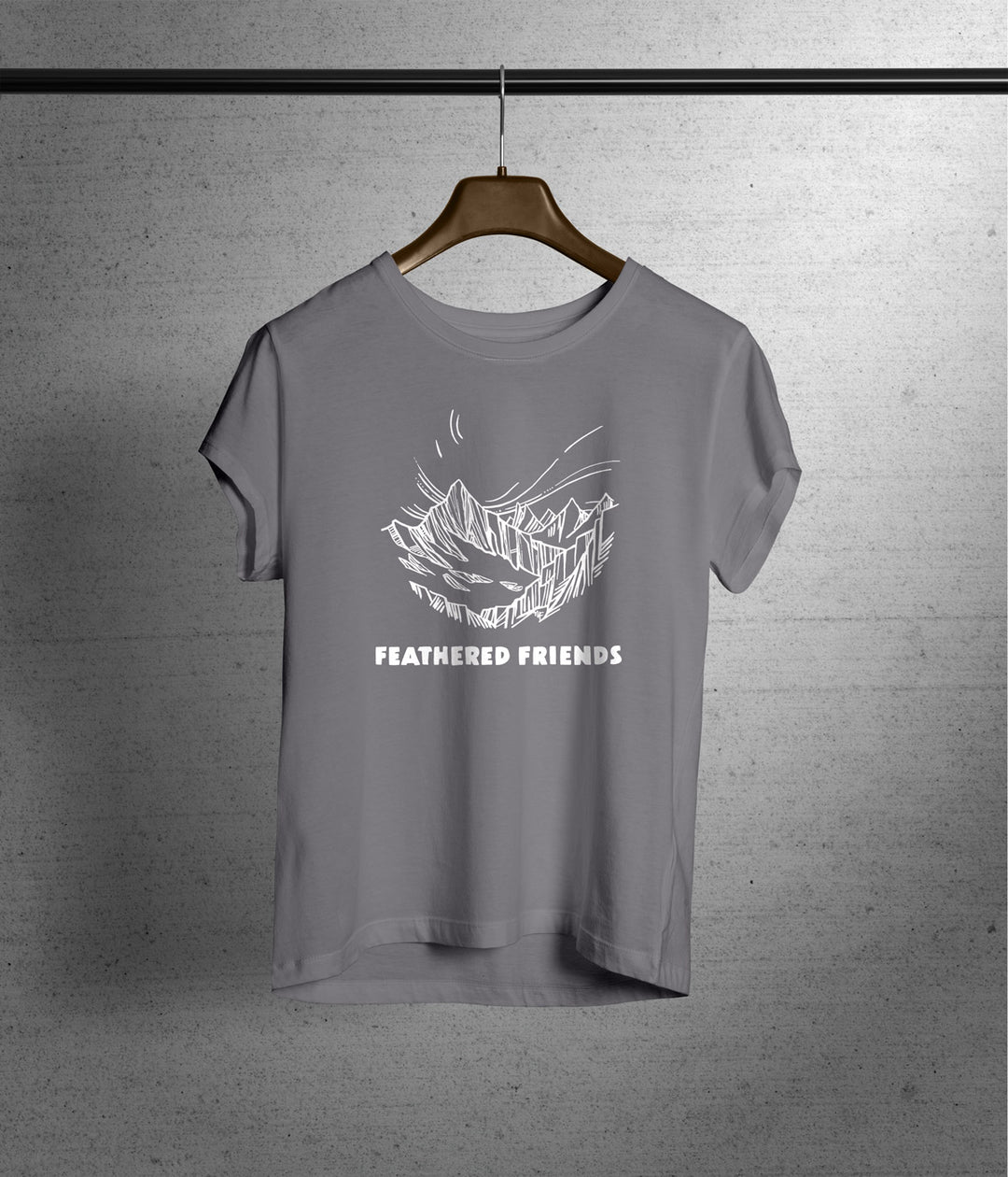 Studio image of Feathered Friends Women's Mountain T-Shirt hanging on coat hanger